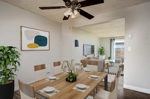 A dining room with a wooden table set for four.