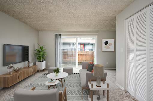 A living room with a flat screen TV on the wall.