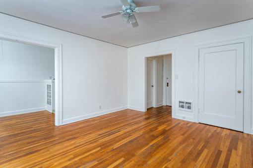 A room with wooden floors and white walls.