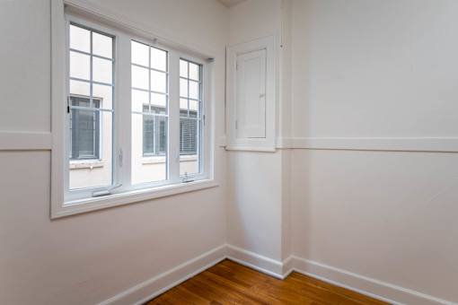 A room with a window and a door.