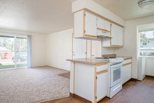 A kitchen with white appliances and cabinets.