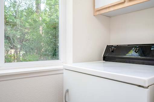A black microwave oven is on a white countertop.