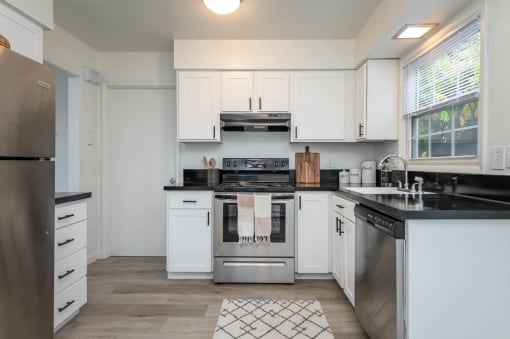 Division 890 | Kitchen with White Cabinetry and Stainless Steel Appliances