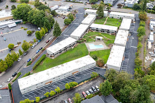A parking lot with cars and a building in the background.