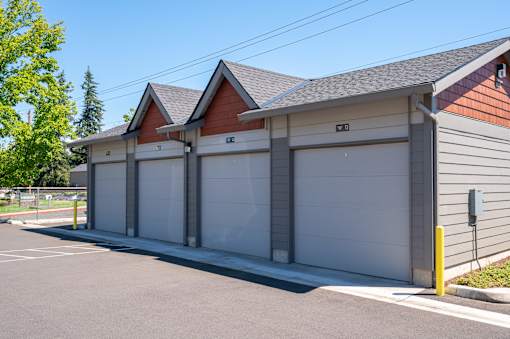 A two-car garage with a brown roof and grey walls.