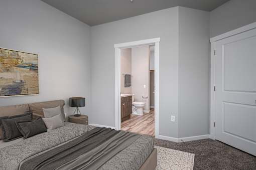 A bedroom with a bed, nightstand, and a painting on the wall.