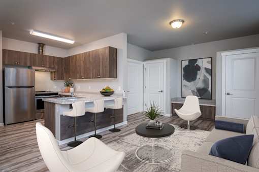 A modern kitchen with a dining area and a living room.