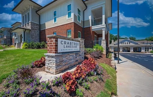 Crabtree Lakeside Apartments is a residential complex with a well-maintained garden in front at Crabtree Lakeside Apartments, Raleigh, NC