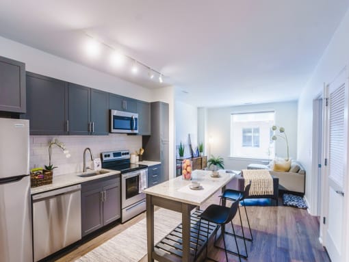 a kitchen and dining room with stainless steel appliances and a table