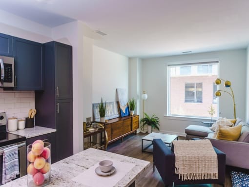 a living room with a kitchen and a table