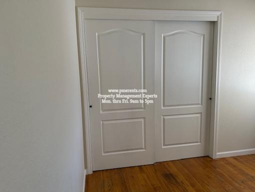 A white door with a glass panel and a website address on it.