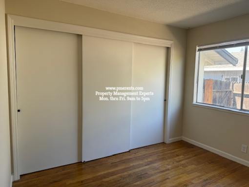 A room with a sliding door and a window.