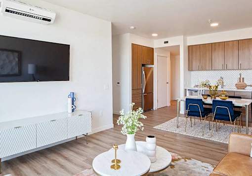 One bedroom with TV mounted on wall and split system air conditioning