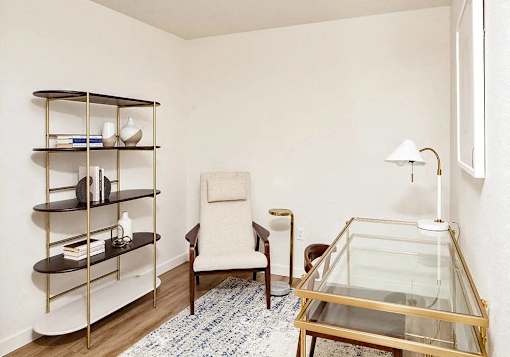 Den with desk and book shelf and lounge chair