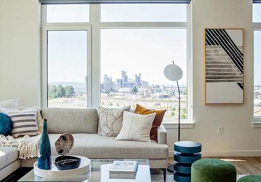 Sectional sofa with large windows facing west in living room