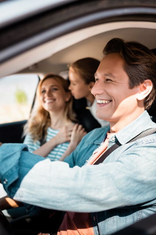 Family laughing while riding in a car