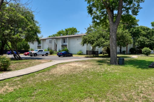 a white building with cars parked in front of it