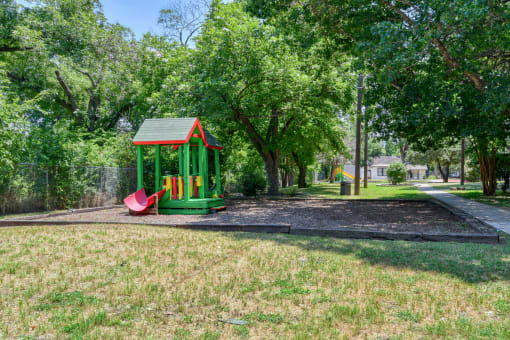 a playground with a slide in a park