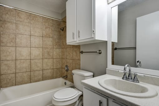 a bathroom with a sink toilet and a bath tub