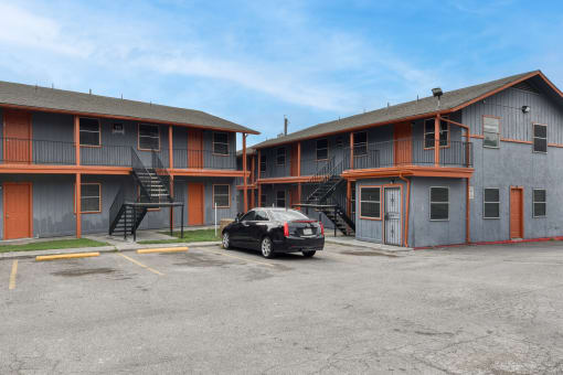 a car parked in front of a motel with a building at The Crossings at Montrose Apartments, San Antonio, TX, 78223