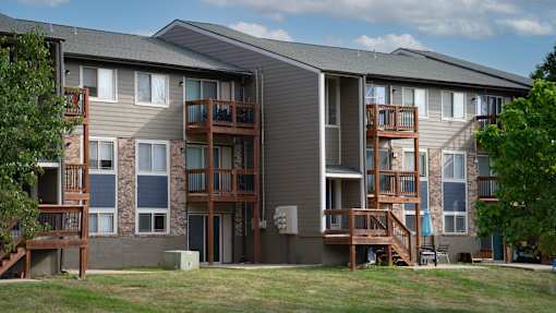 Apartment building with balconies and a clear sky in the background.