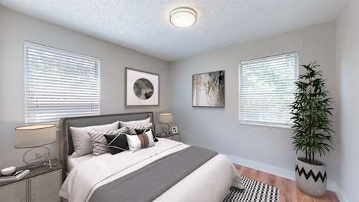 A bedroom with a bed, nightstand, and two framed pictures on the wall.