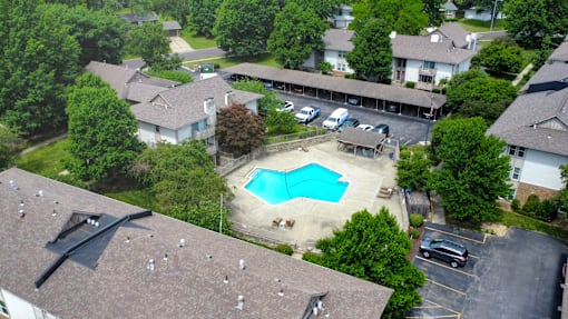 A swimming pool surrounded by houses.