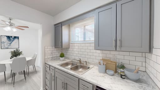 an open kitchen and dining room with a table and a sink