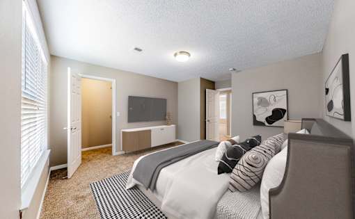 A bedroom with a bed, a television, and a window with blinds.