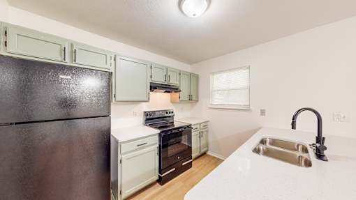 a kitchen with stainless steel appliances and white counter tops