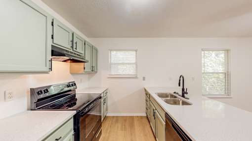 a kitchen with white counter tops and a sink