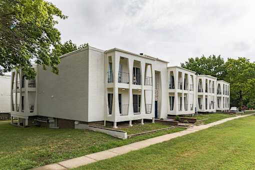 A row of white buildings with balconies and windows.
