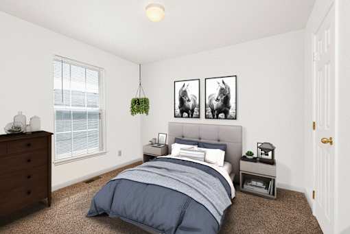 A bedroom with a bed, nightstand, and two framed pictures on the wall.