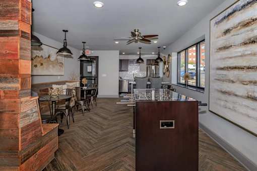 A room with a wooden floor and a large painting on the wall.