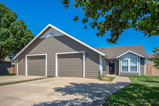 A house with two garages and a driveway.