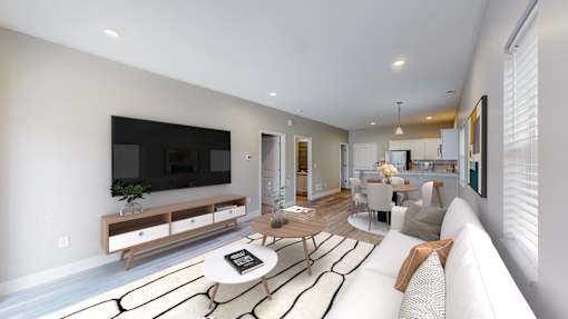 A modern living room with a white sofa and a television.