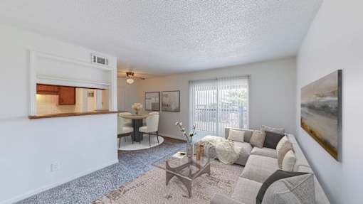 A living room with a grey couch and a coffee table.