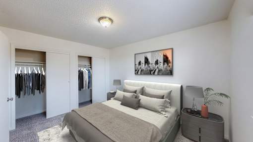 A bedroom with a bed, a nightstand, and a painting on the wall.