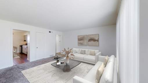 A living room with a white couch and a coffee table.