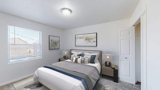 A bedroom with a large bed and a window overlooking a residential area.