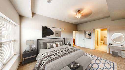 A bedroom with a large bed and a ceiling fan.