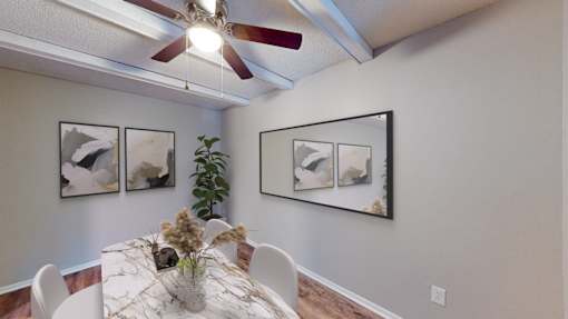 our dining room with a table and chairs and a ceiling fan