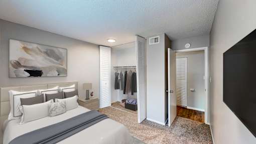 a bedroom with a bed and a closet