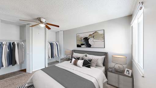 a bedroom with a bed and a ceiling fan