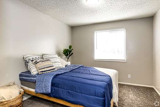 a bedroom with a bed and a window