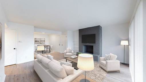 A modern living room with a fireplace and a large painting on the wall.