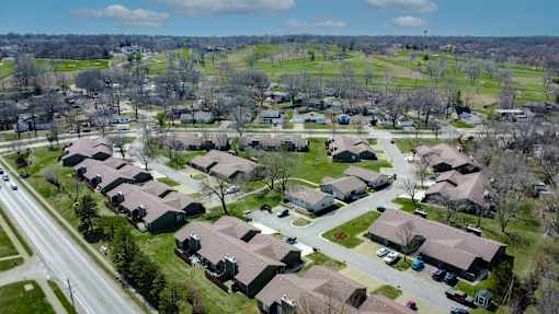 A suburban neighborhood with houses and a road.