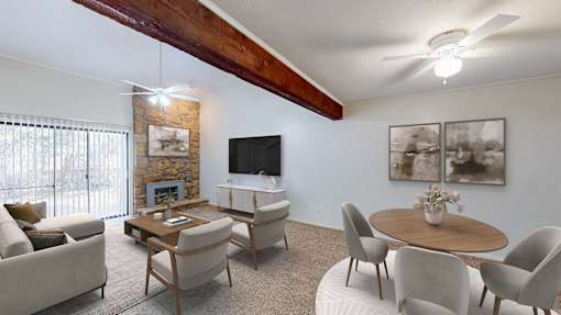 A living room with a fireplace and a flat screen TV.