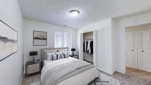 A bedroom with a large bed and a painting on the wall.