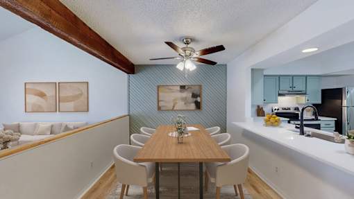 A dining room with a table and chairs.
